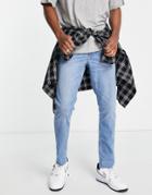 Asos Design Stretch Slim Jeans In Mid Wash Blue With Raw Hem