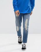 Asos Tapered Jeans In Dark Wash Blue With Heavy Rip And Repair - Blue