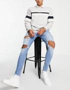 Asos Design Spray On Jeans In Power Stretch In Mid Wash With Heavy Rips-blues