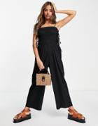 Asos Design Shirred Strappy Jumpsuit With Tie Side Detail In Black