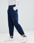 Asos Design Tapered Jean With Curve Seam In Indigo Wash With Utility Pockets - Blue