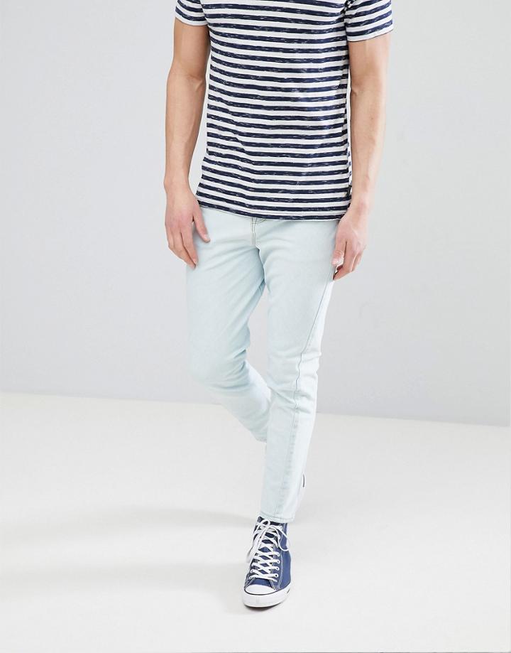 Asos Design Skinny Twisted Seam Jeans In Mid Wash Blue With Raw Hem