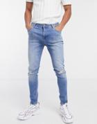 Asos Design Spray On Jeans With Power Stretch In Mid Wash Blue With Rips