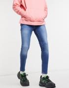 Asos Design Spray On Jeans With Power Stretch In Mid Wash Blue-blues