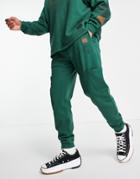 Asos Design Matching Tapered Joggers With Cargo Pockets And Multi Placement Outdoors Prints-green