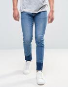 Asos Skinny Ankle Grazer Jeans With Shadow Patch Detail And Raw Hem In Mid Blue - Blue