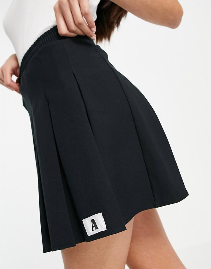 Asos Design Mini Pleated Tennis Skirt With 'a' Tab Detail In Black