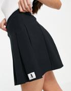 Asos Design Mini Pleated Tennis Skirt With 'a' Tab Detail In Black