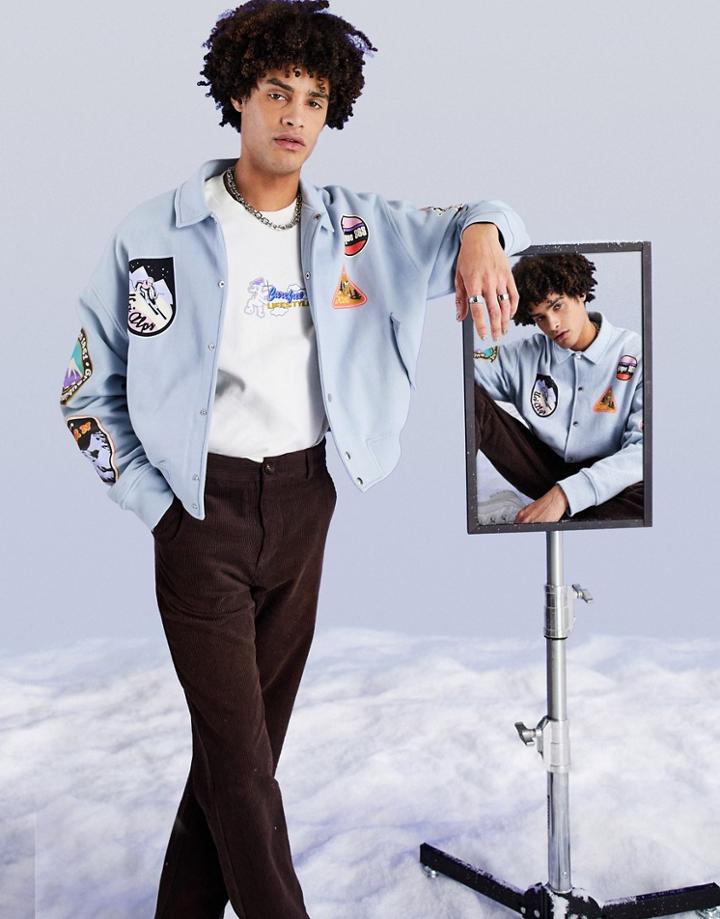 Asos Design Oversized Jersey Coach Jacket In Light Blue With Ski Patch Prints-blues