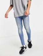 Asos Design Organic Cotton Blend Spray On Jeans With Powerstretch In Vintage Light Wash With Abrasions-blues
