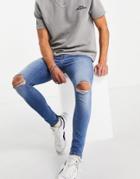 Asos Design Spray On Jeans With Power Stretch In Mid Wash With Knee Rips-blues
