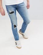 Asos Skinny Jeans In Mid Wash Blue With Rip & Repair - Blue