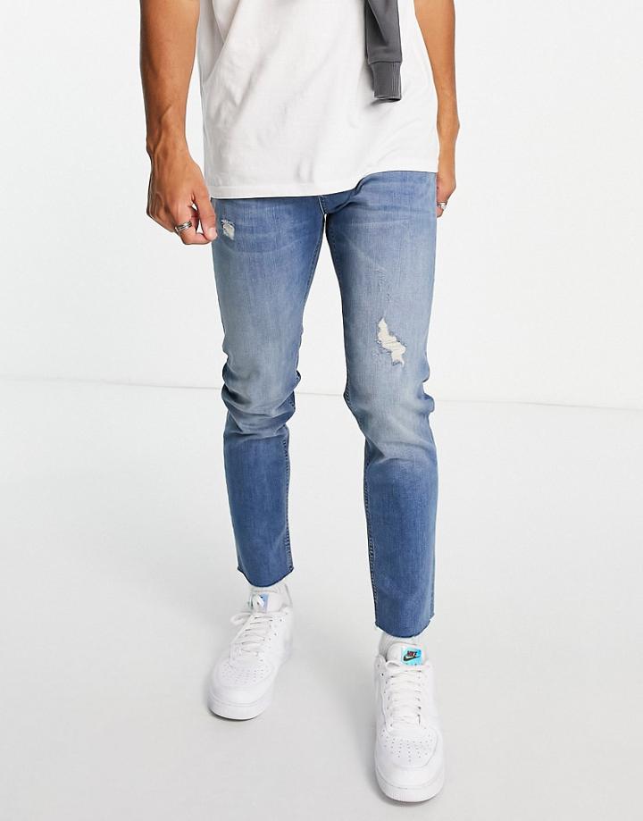 Asos Design Skinny Jeans In Mid Wash With Abrasions And Raw Hem-blues