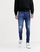 Criminal Damage Skinny Jeans In Midwash Blue With Distressing