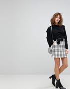 Lost Ink Mini Skirt In Check With Faux Leather Belt And Pom Pom - Black