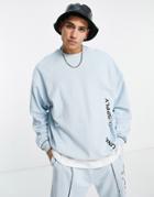 Asos Unrvlld Spply Oversized Sweatshirt With Graphic Prints In Light Blue-blues