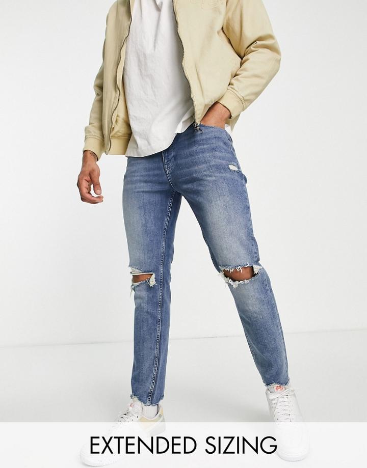 Asos Design Skinny Jeans In Mid Blue With Knee Rips And Raw Hem Detail