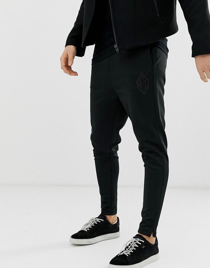 Religion Tapered Fit Sweatpants In Black With Zip Hem - Black