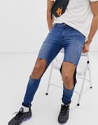 Asos Design Super Spray On Jeans In Mid Blue With Open Rips - Blue