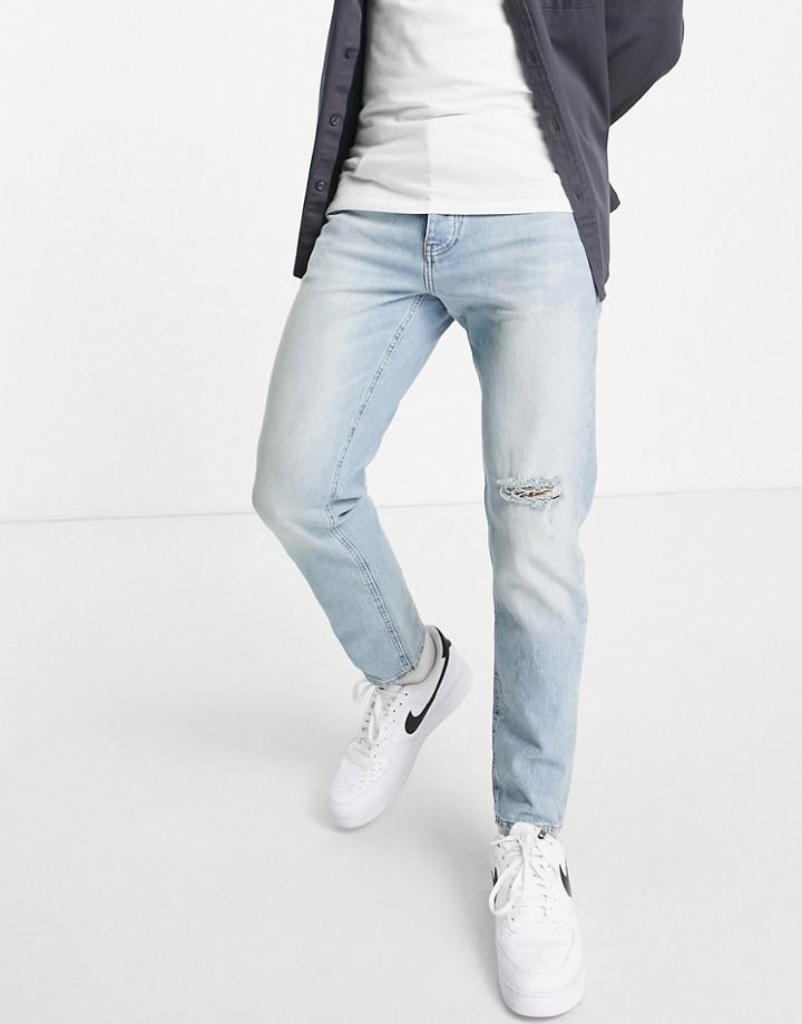 Asos Design Tapered Jeans In Vintage Light Wash With Rip-blues