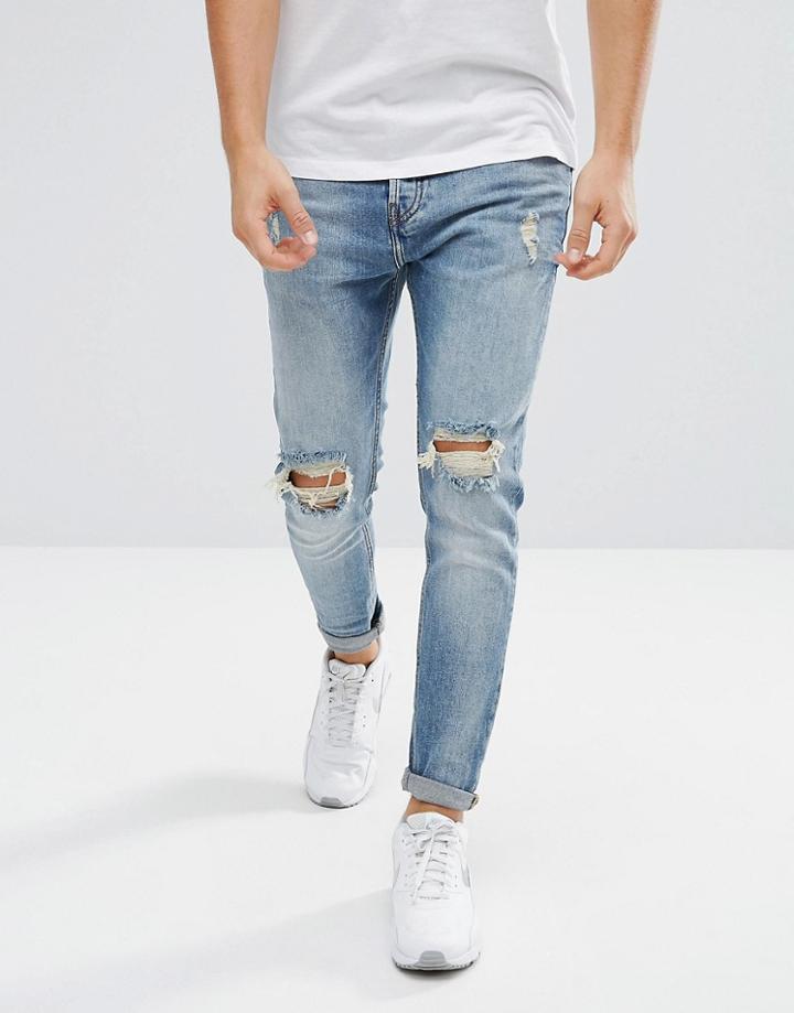 Pull & Bear Ripped Jeans In Carrot Fit In Mid Wash Blue - Blue