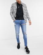 Asos Design Skinny Jeans In Mid Wash Blue With Heavy Rips-blues