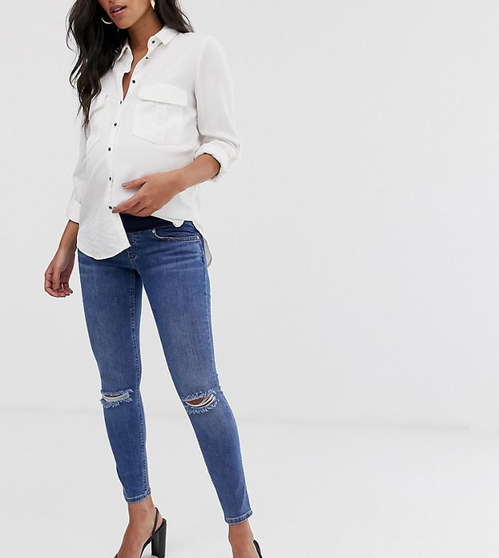 Asos Design Maternity Lisbon Mid Rise Skinny Jeans In Mid Wash Blue With Frayed Knee Rips And Under The Bump Waistband
