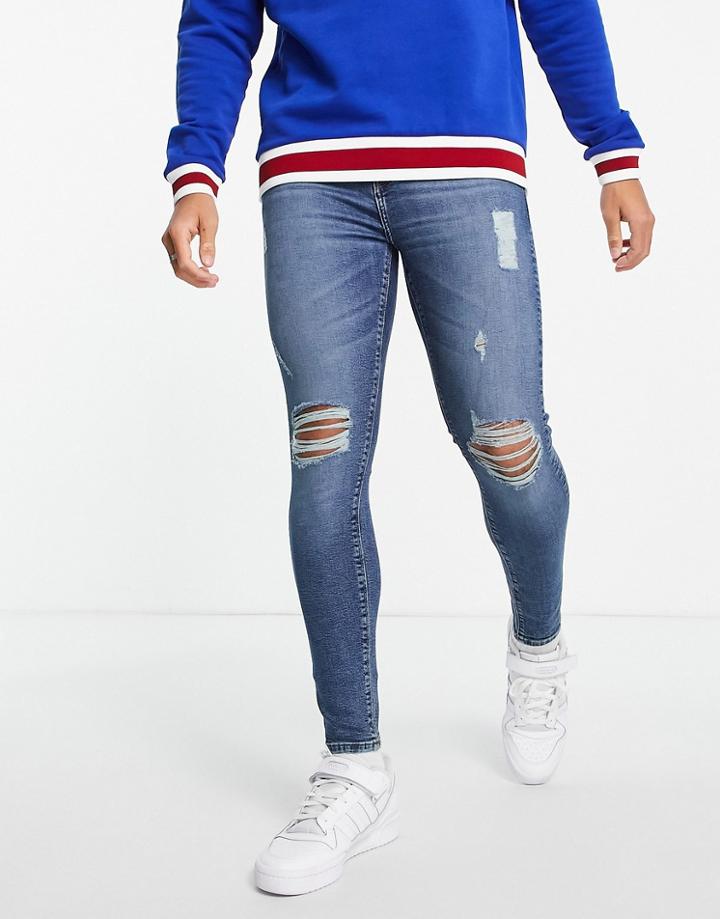 Asos Design Spray On Jeans With Power Stretch In Dark Wash Blue With Heavy Rips-blues