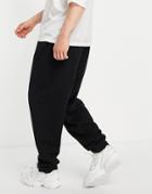 Asos Design Oversized Sweatpants In Black With Toggle Hem