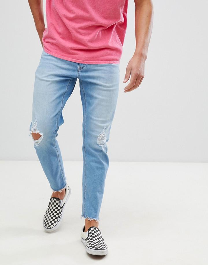 Asos Design Tapered Jeans In Vintage Light Wash With Rips-blue