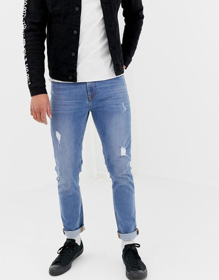 Asos Design Skinny Jeans In Light Wash Blue With Abrasions - Blue