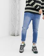 Bershka Join Life Organic Cotton Tapered Carrot Fit Jeans With Rip And Abrasions In Mid Blue