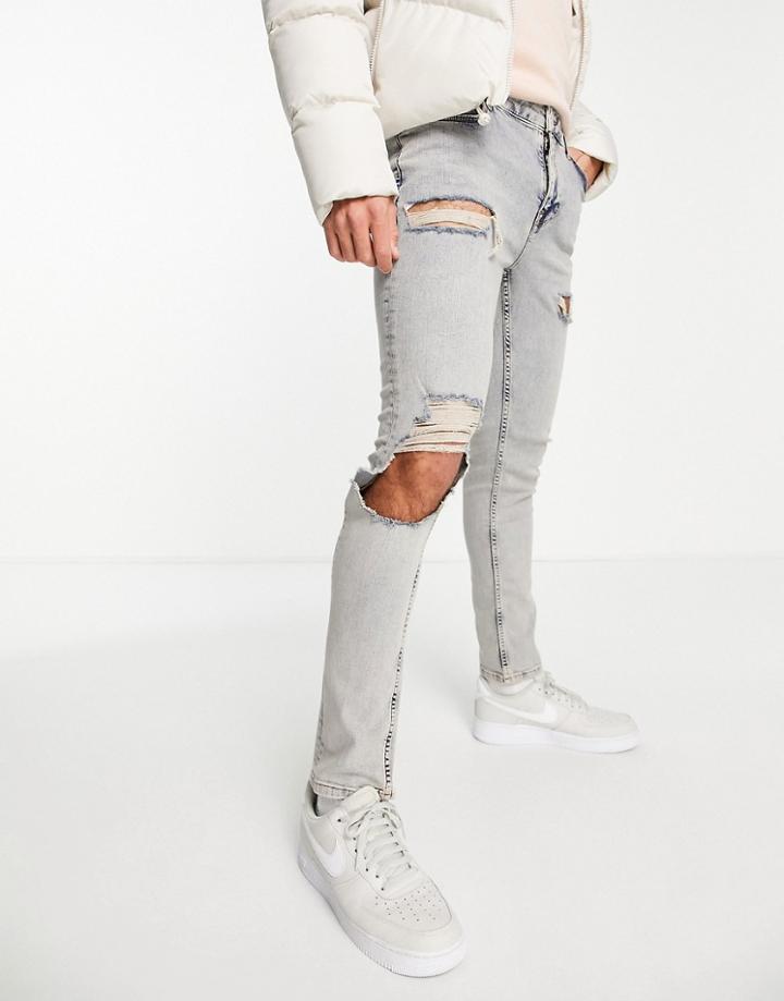 Asos Design Skinny Jeans In Mid Wash With Heavy Tint And Thigh Rip-blue