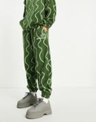 Asos Daysocial Relaxed Sweatpants In Polar Fleece With All-over Squiggle Print In Green