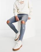 Asos Design Spray On Jeans In Power Stretch In Tinted Mid Wash With Rips And Raw Hem-blues