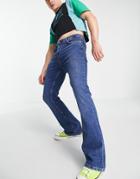 Asos Design Flared Jeans In Mid Wash Blue