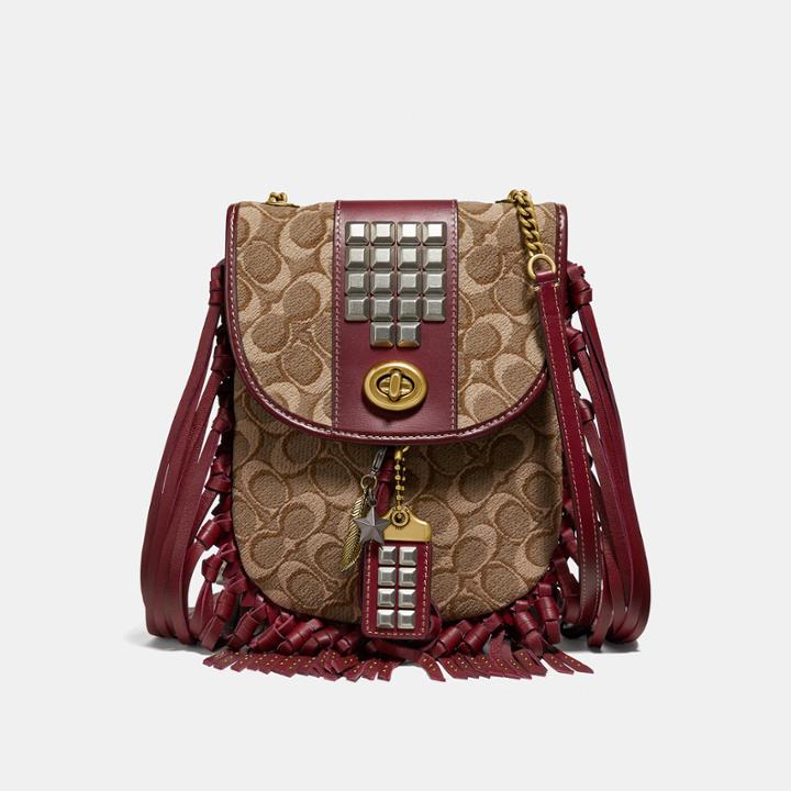 Coach Fringe Saddle Bag In Signature Jacquard With Pyramid Rivets
