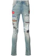 Amiri Distressed Skinny Jeans With Patch Appliqués - Blue