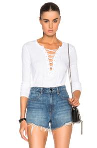 Pam & Gela Long Sleeve Lace Up Top In White