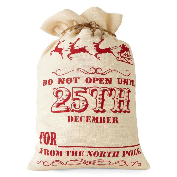 North Pole Trading Co. Winter Lodge Open The 25th Burlap Santa Bag