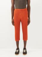 Homme Pliss Issey Miyake - Cropped Technical-pleated Slim-leg Trousers - Mens - Orange