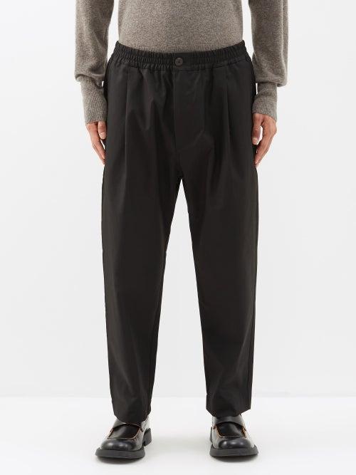 Studio Nicholson - Pleated Cotton-blend Trousers - Mens - Black