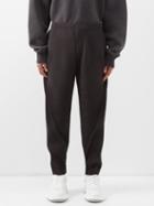 Homme Pliss Issey Miyake - Arc Technical-pleated Tapered-leg Trousers - Mens - Dark Grey