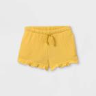 Toddler Girls' Ruffle Pull-on Shorts - Cat & Jack Light Mustard 12m,