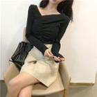 Long-sleeve Diagonal Neckline T-shirt / A-line Faux Leather Skirt