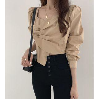 Buckled Asymmetrical Top