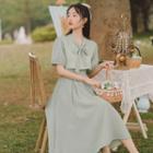 Short-sleeve Plaid Tie-neck Midi A-line Dress