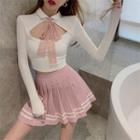Long-sleeve Tie-neck Cut-out T-shirt / Striped Mini Pleated Skirt