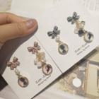 Non-matching Bow Faux Pearl Cat Print Disc Dangle Earring