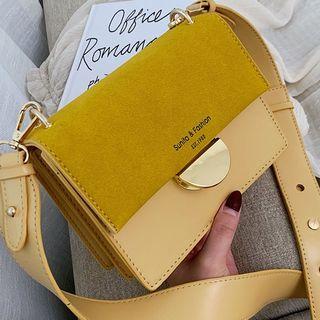 Half Disc Buckled Belted Cross Bag
